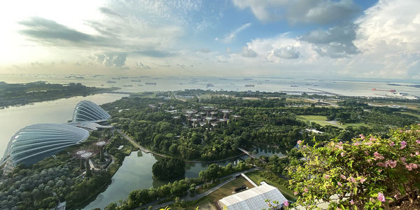 High angle view of cityscape by sea against sky