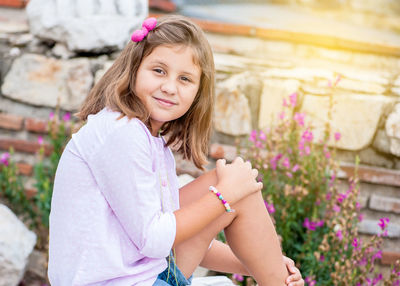 Portrait of happy girl with pink flowers