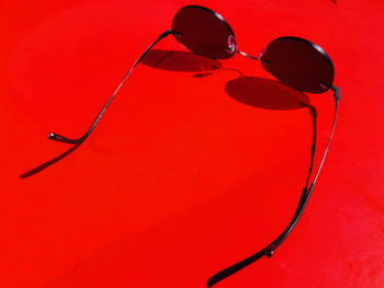 Close-up of water drop against red background