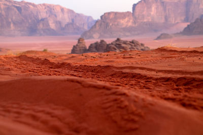 Surface level of barren landscape against sky