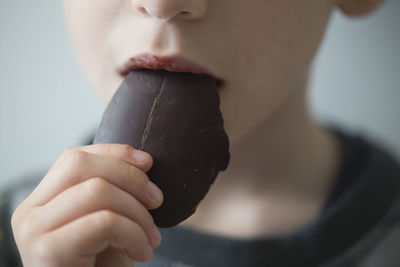 Close-up of boy eating chocolate