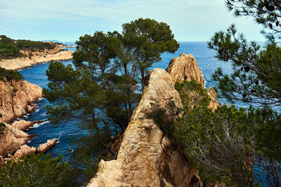 Rock formations by sea against sky