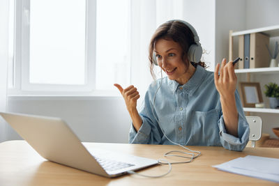 Young woman using laptop at office