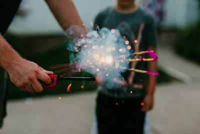 Close-up of hand holding sparkler
