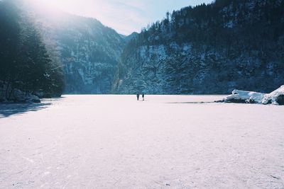 Man walking on snow covered landscape