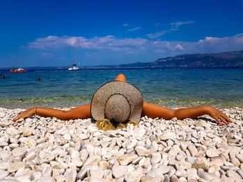 Scenic view of rocks on beach against sky
