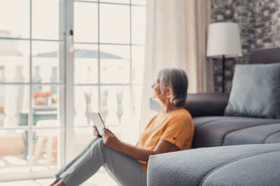 Young woman using laptop at home