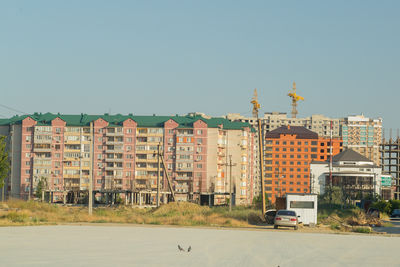 Buildings in city against clear sky