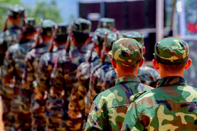 Rear view of army soldiers standing in parade