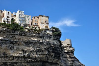 Low angle view of buildings against blue sky