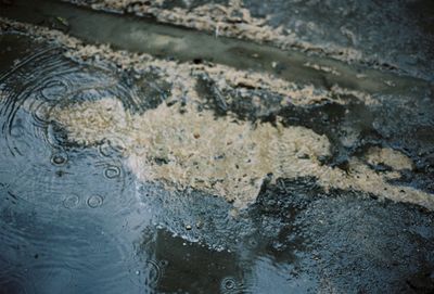 High angle view of text on wet shore