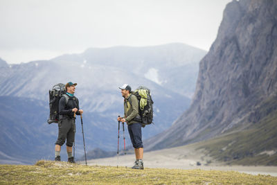 Two friends share a laugh while backpacking in akshayak pass