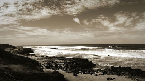 Scenic view of sea against cloudy sky