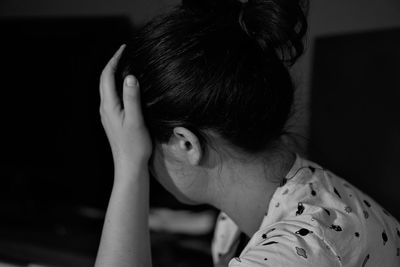 Side view of sad woman at home