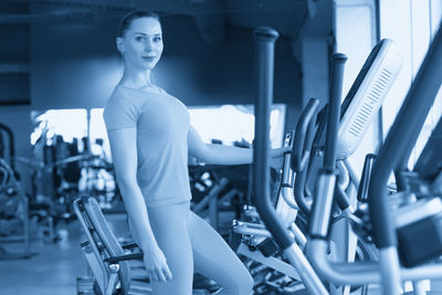 Young woman exercising in gym