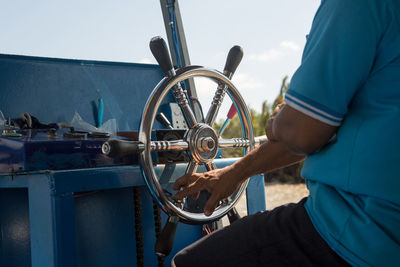 Man holding umbrella against boat