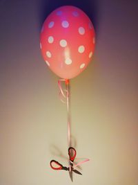 Close-up of multi colored balloons against wall