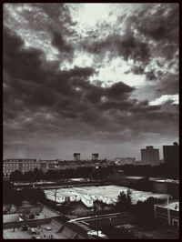 Cityscape against cloudy sky