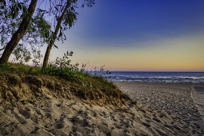 Beautiful pink sunset clouds over the baltic sea beach