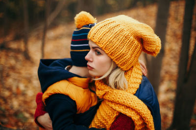 Smiling woman and son during autumn