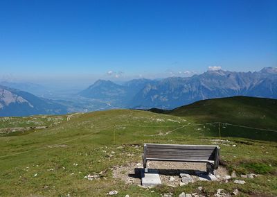 Scenic view of mountains against blue sky