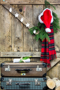 Suitcases by scarf and santa hat