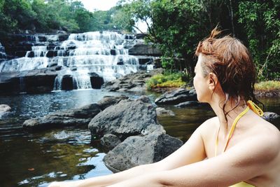 Woman looking at waterfall