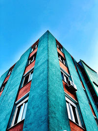 Low angle view of building against clear blue sky