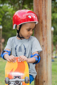 Full length of a boy holding skateboard 