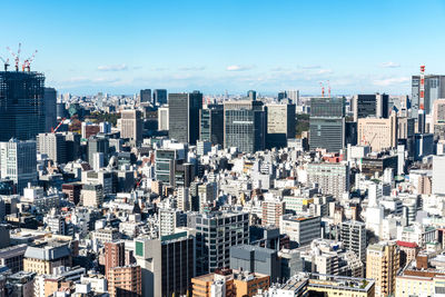 Aerial view of modern buildings in city against sky