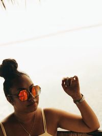 Portrait of woman with sunglasses against sky