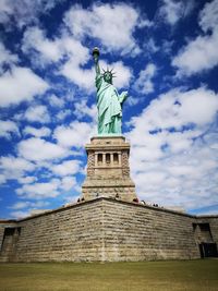 Low angle view of statue against cloudy sky