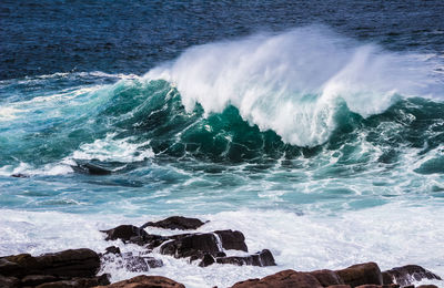 Waves breaking on rocks at shore