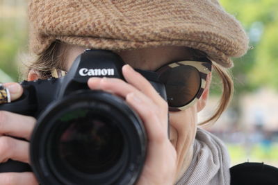 Cropped image of person holding camera