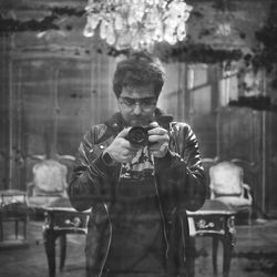 Close-up of young man holding camera