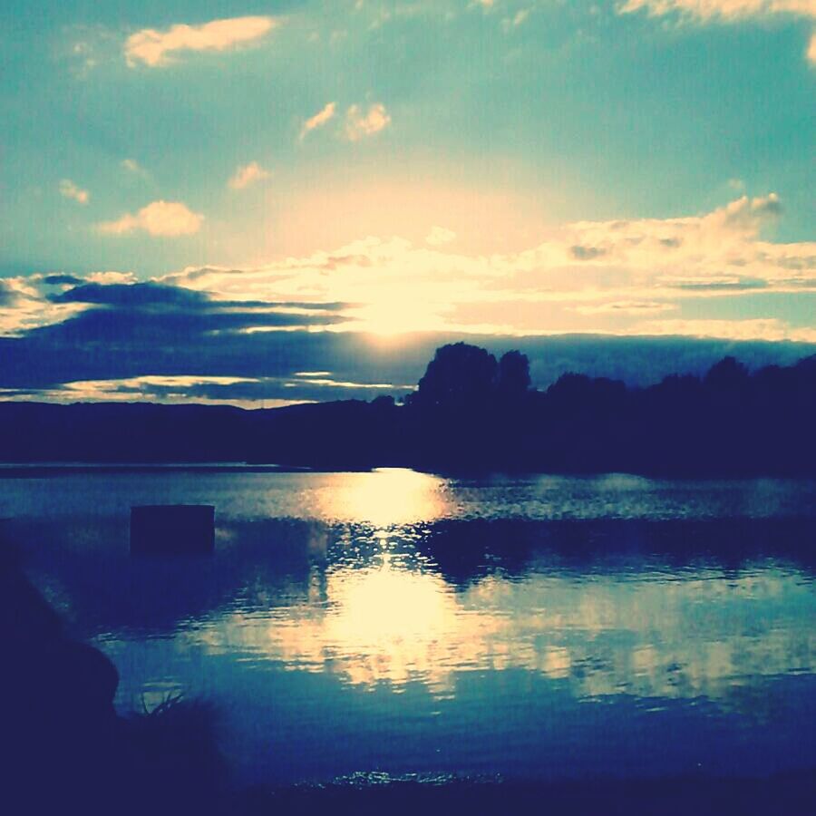 water, tranquil scene, reflection, scenics, sky, tranquility, sunset, beauty in nature, lake, silhouette, cloud - sky, nature, waterfront, idyllic, cloud, calm, mountain, sea, outdoors, sunlight