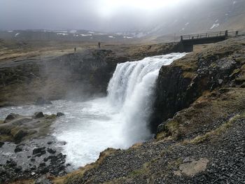 Scenic view of waterfall against sky