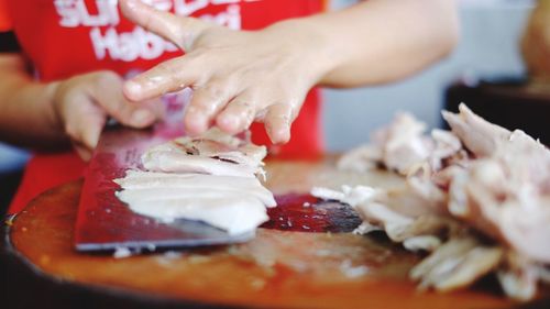 Cropped image of hand holding food