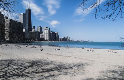 Panoramic view of beach and city against sky