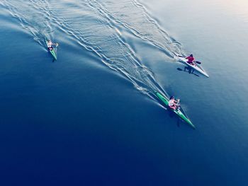 High angle view of people kayaking in lake