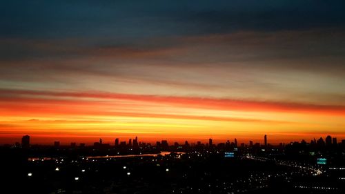 Silhouette buildings against sky during sunset