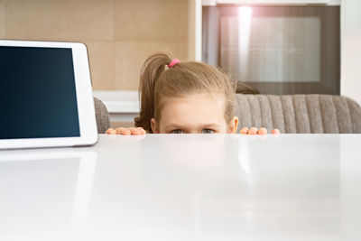 Portrait of girl with smart phone on table