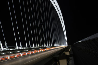 Light trails on bridge in city at night