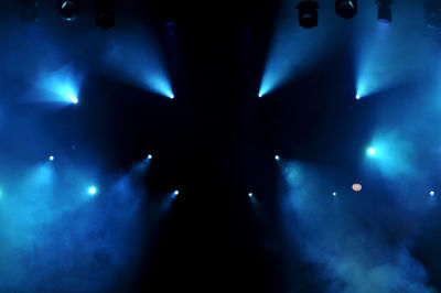 Low angle view of illuminated lights at night