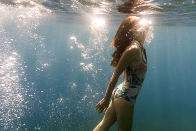 Young woman swimming in sea