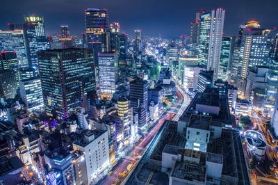 High angle view of illuminated buildings in city at night