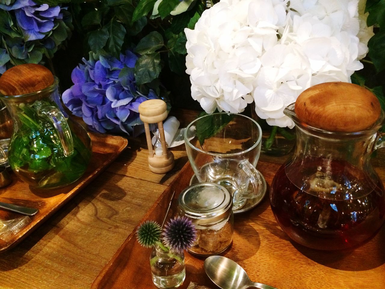 indoors, flower, table, freshness, vase, still life, glass - material, high angle view, fragility, decoration, flower arrangement, arrangement, food and drink, drinking glass, variation, petal, no people, potted plant, transparent, flower pot