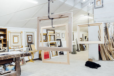 Workshop with frames hanging and dog lying on floor