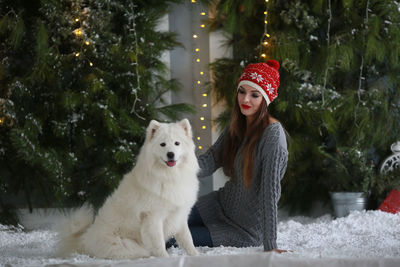 Young woman with horse standing in snow