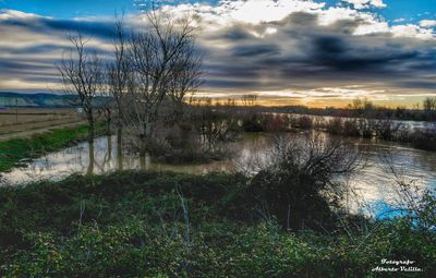 Scenic view of lake against sky during sunset